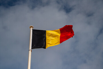 The flag of the country Belgium. It consists of three vertical rectangles in the colours black red...