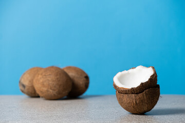 Coconuts on blue background, space for text