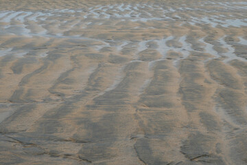 Water grooves in the sand at low tide
