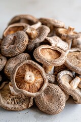 Overhead view of dried shiitake mushrooms on white background
