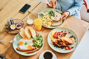Closeup of couple eating delicious breakfast together in restaurant