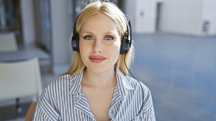 Portrait of a casual young woman wearing headphones outdoors on an urban city street.