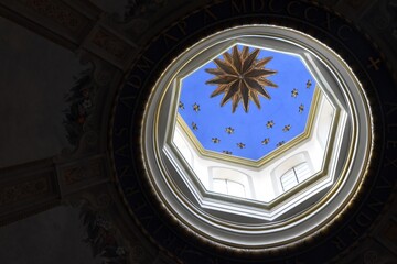 a church dome in italy from the inside with a ceiling and stars painted on it