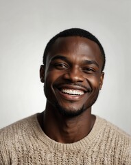 Obraz premium white background studio portrait of smiling handsome black african guy model with clear smooth skin and white teeth