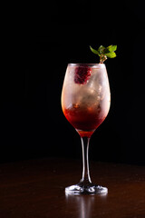 drink alcoholic cocktail with silvestry blackberry and mint black background
