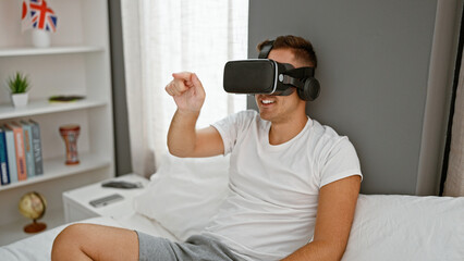 Hispanic man wearing virtual reality headset in modern bedroom enjoys gaming experience indoors