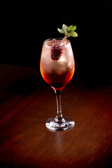 drink alcoholic cocktail with silvestry blackberry and mint on wooden table