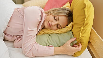 A young blonde woman peacefully sleeping in a brightly colored bedroom, showcasing relaxation and comfort.