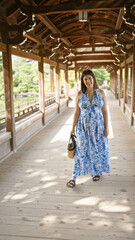 Beautiful hispanic woman radiating joy, confidently posed standing, smiling to the camera while walking to heian jingu in traditional kyoto, japan