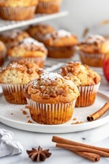 Freshly Baked Apple Cinnamon Muffins With Powdered Sugar on a White Plate