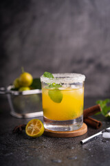 Fresh summer orange mojito with tangerine orange, mint and ice on black background