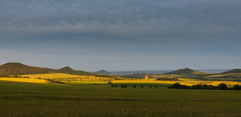 Ceske stredohori, north Czech hill landscape at  dramatic sunset light. Nature, weather panoramic...