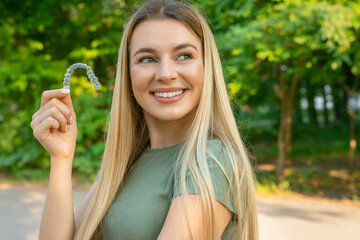 Woman with perfect smile after invisible dental aligners aligners treatment