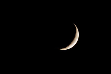 Real photograph of Crescent moon on black sky.