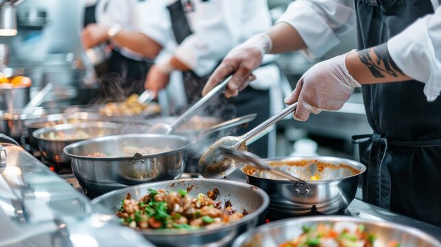 A group of chefs are cooking food in a kitchen