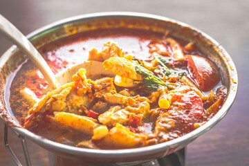 Thai Tum Yum Soup with Chicken, mushrooms, served in a mini steamboat