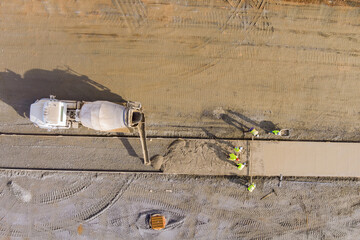 Mason workers introduce concrete pouring process from mixer truck for footpath sidewalk