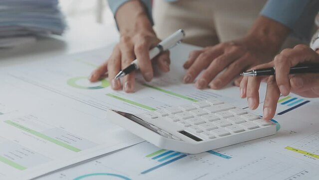 Close up young woman using calculator, managing household monthly budget, summarizing taxes or bills, planning future investments, doing financial affairs at home, accounting bookkeeping concept.