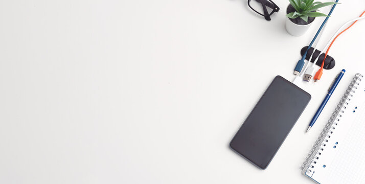 Office desktop with smartphone and accessories - Powered by Adobe