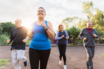 Group of diverse senior people jogging together at park