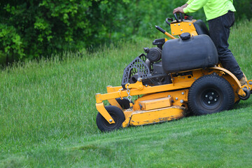 manual worker mowing the lawn