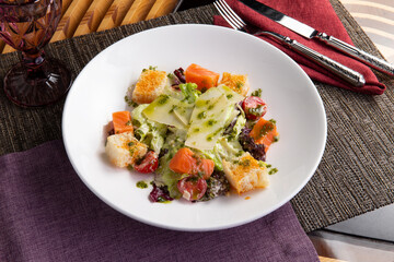 Salad with salmon in a plate.