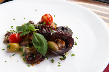 Cooked octopus tentacles in a plate.