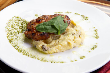 Cooked pork steak and mashed potatoes in a plate.