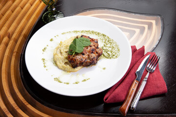 Cooked pork steak and mashed potatoes in a plate.