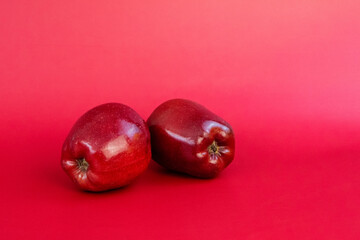 Red apples on a red background
