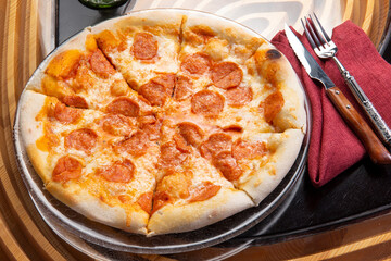 Pizza with pepperoni in a plate.