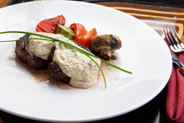 Beef midallions with pepper sauce in a plate.