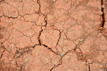 the red clay is cracked top view drought soil 