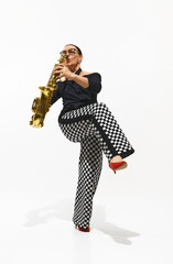 Fototapeta premium Dynamic image of elegant woman, stylish saxophonist playing saxophone with soul and energy isolated on white background. Concept of music, festival, concert, hobby, talent, performance