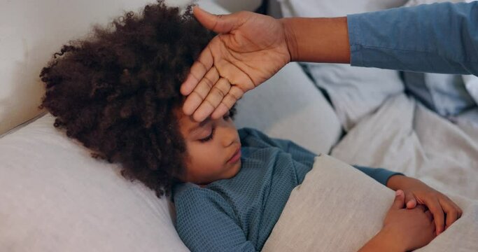 Fever, sick and parent with child in bed for flu, virus or infection with symptoms at house. Illness, care and person checking boy kid forehead for temperature with cold in bedroom at family home.