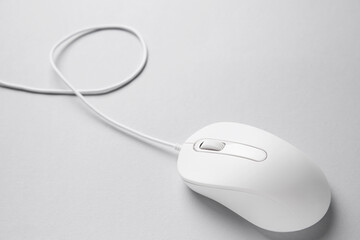 One wired mouse on grey background, closeup