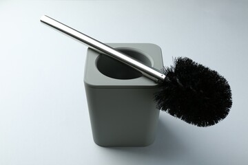 Toilet brush and holder on white background