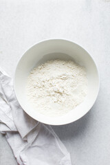 top view of All purpose flour in a white bowl, overhead view of baking flour in a bowl