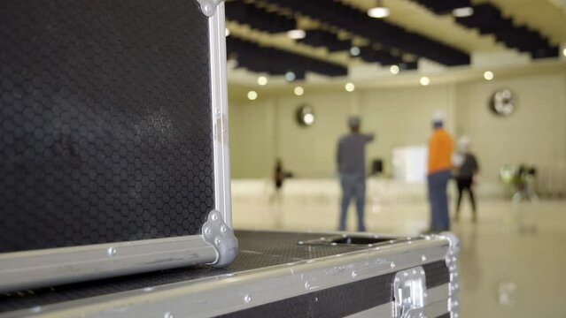  out-of-focus engineers at work setting up a stage for a conference