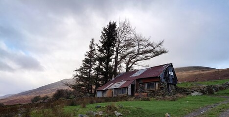 OLD RUSTIC ABANDONED HOUSE IN THE MOUNTAINS