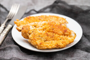 Delicious crispy chicken fillet in bread crumbs on plate