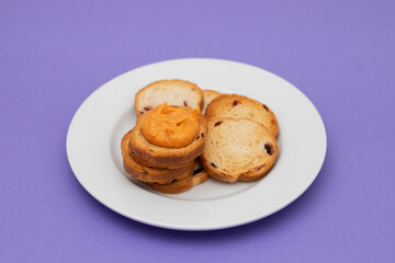 Freshly baked rusks with raisins, on small plate