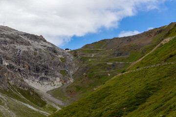 Serpentine road, summit of Stelvio Pass and mountain alps panorama in Italy