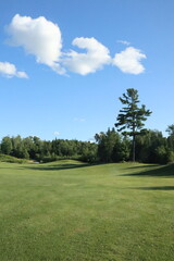 golf course with sky and clouds