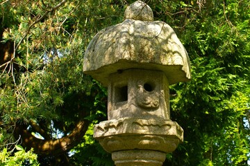 A traditional Japanese toro lantern made of stone placed in a park
