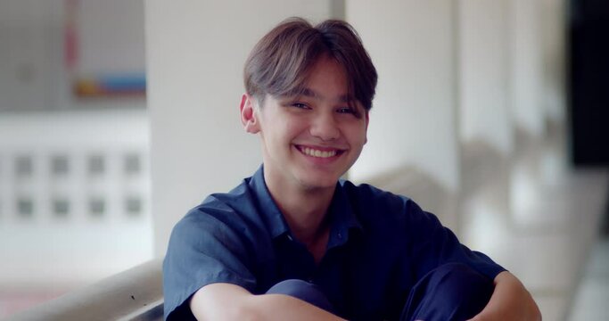 A happy smile of a handsome male high school student who is half Asian-European.