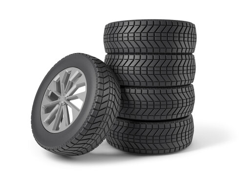 A stack of vehicle wheels and tires isolated from the white background