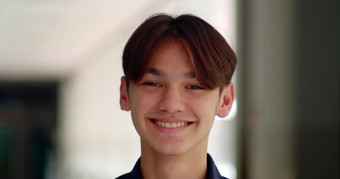 A happy smile of a handsome male high school student who is half Asian-European.