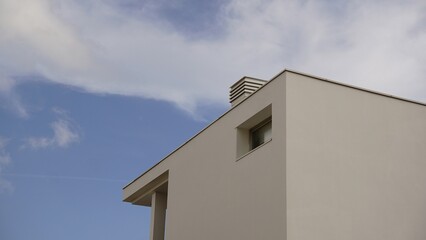 corner of modern and minimalist house facade against the sky
