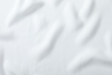 Fototapeta premium Texture of white fabric as background, top view